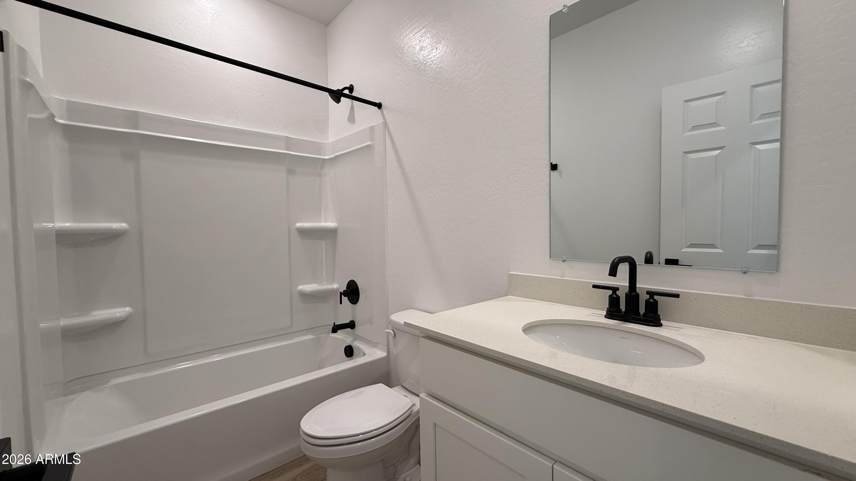 46818 West Old Timer Road Maricopa, AZ 85139 - Photo 8 of 34 a bathroom with a sink a toilet and shower