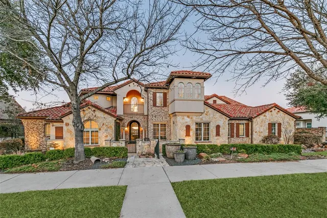 a front view of a house with a garden and plants
