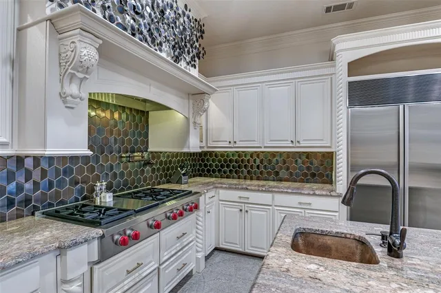 a kitchen with stainless steel appliances granite countertop a stove and a sink