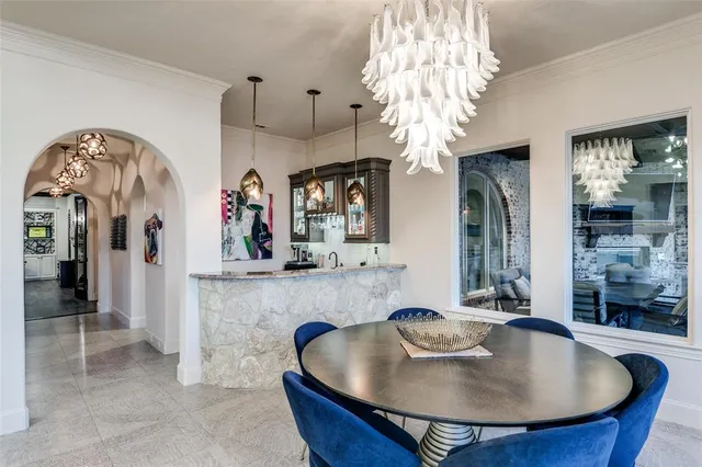 a view of a hallway with furniture and chandelier