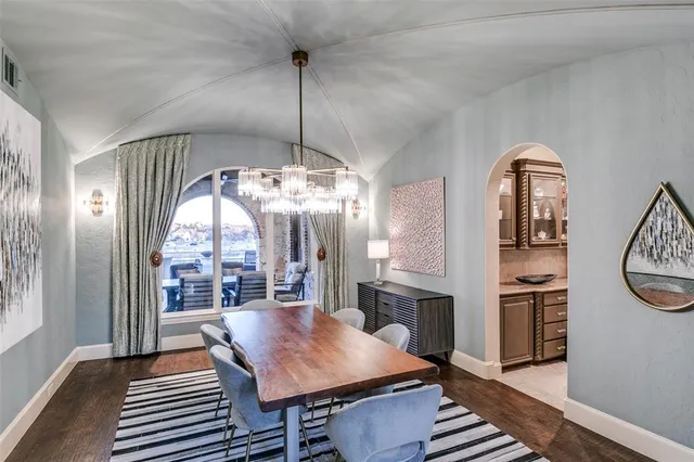 a spacious bedroom with a large bed and a chandelier