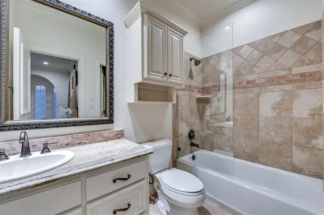 a bedroom with a bed couches and a flat tv screen