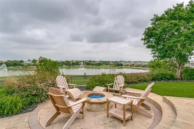 a view of a lake with couches in the patio and a yard