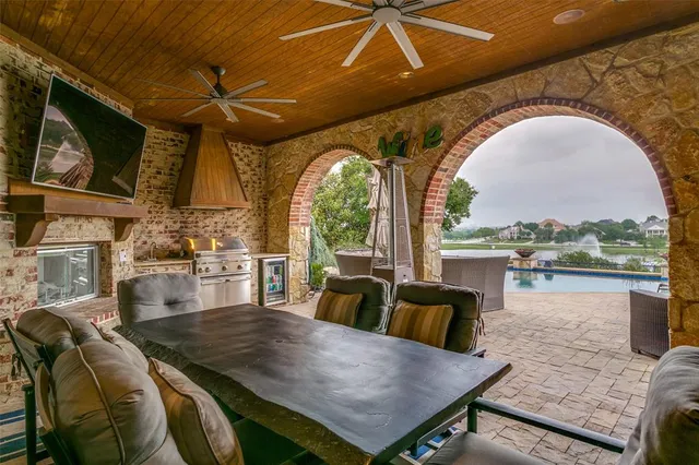 a living room with furniture a flat screen tv and a large window