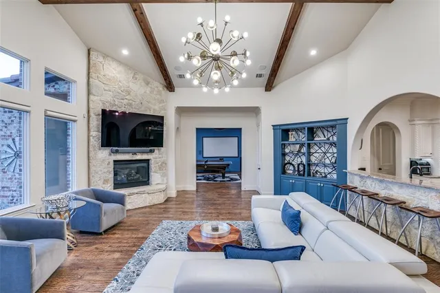 a living room with furniture and a chandelier