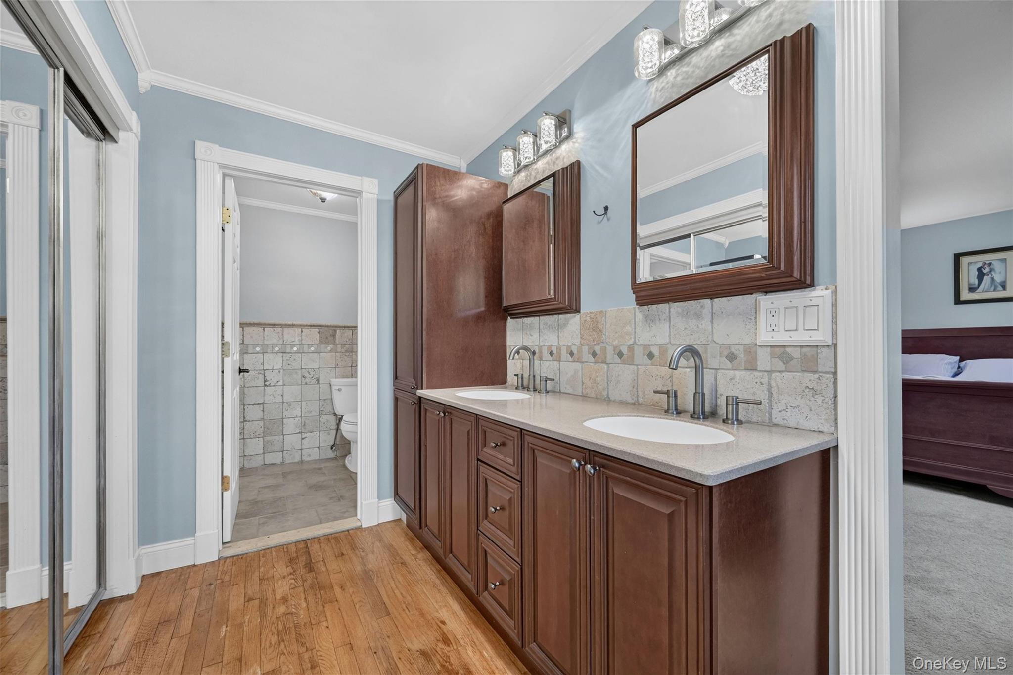 5 Hedges Road Warwick, NY 10990 - Photo 27 of 48 The updated en suite bath features tasteful neutral finishes, dual sinks, warm cabinetry, and closet access within the bath area.