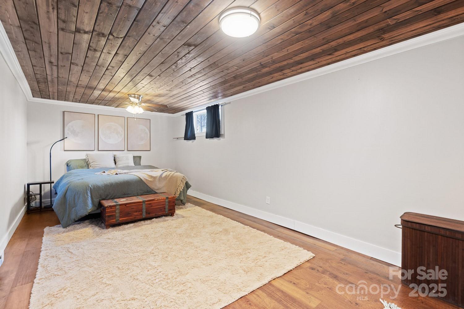 39 Edwards Road Fairview, NC 28730 - Photo 14 of 20 a bedroom with a bed and a chair