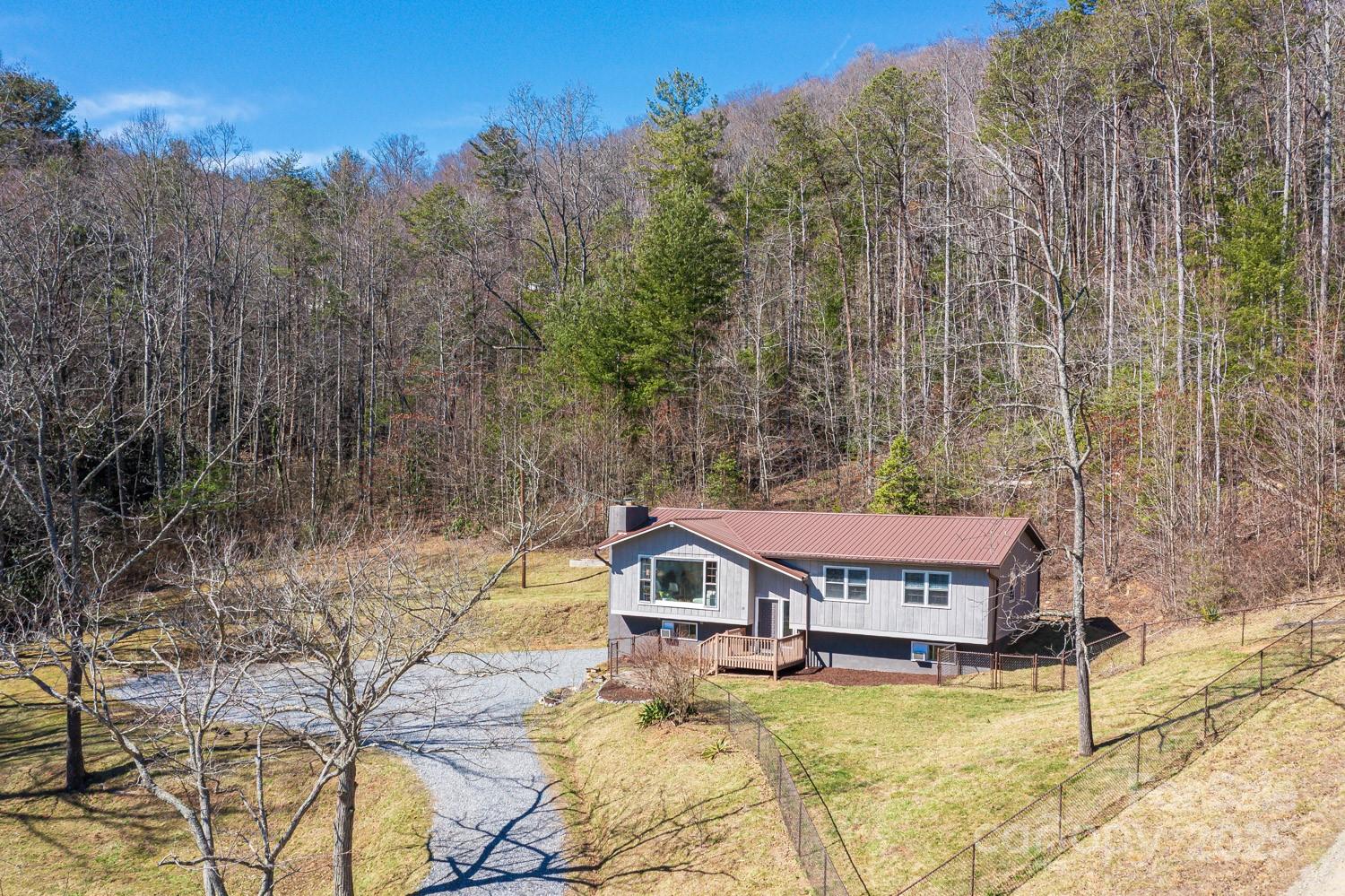 39 Edwards Road Fairview, NC 28730 - Photo 2 of 20 a view of a house with a yard and sitting area