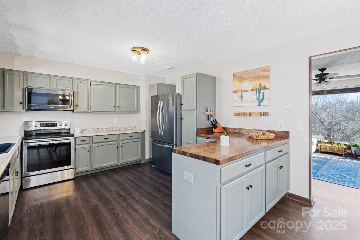 39 Edwards Road Fairview, NC 28730 - Photo 7 of 20 a kitchen with stainless steel appliances kitchen island granite countertop a stove a sink and a refrigerator