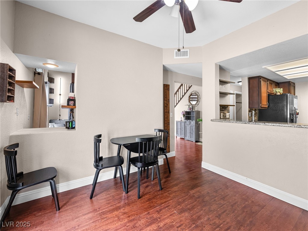 353 Seine Way, Unit N Henderson, NV 89014 - Photo 11 of 36 Dining space featuring wood finished floors, a ceiling fan.