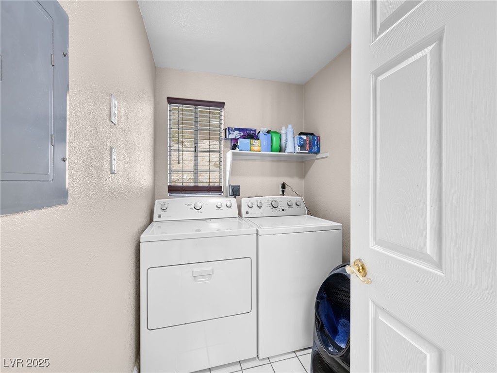 353 Seine Way, Unit N Henderson, NV 89014 - Photo 14 of 36 Washroom with laundry area, electric panel, light tile patterned floors, and washer and clothes dryer.