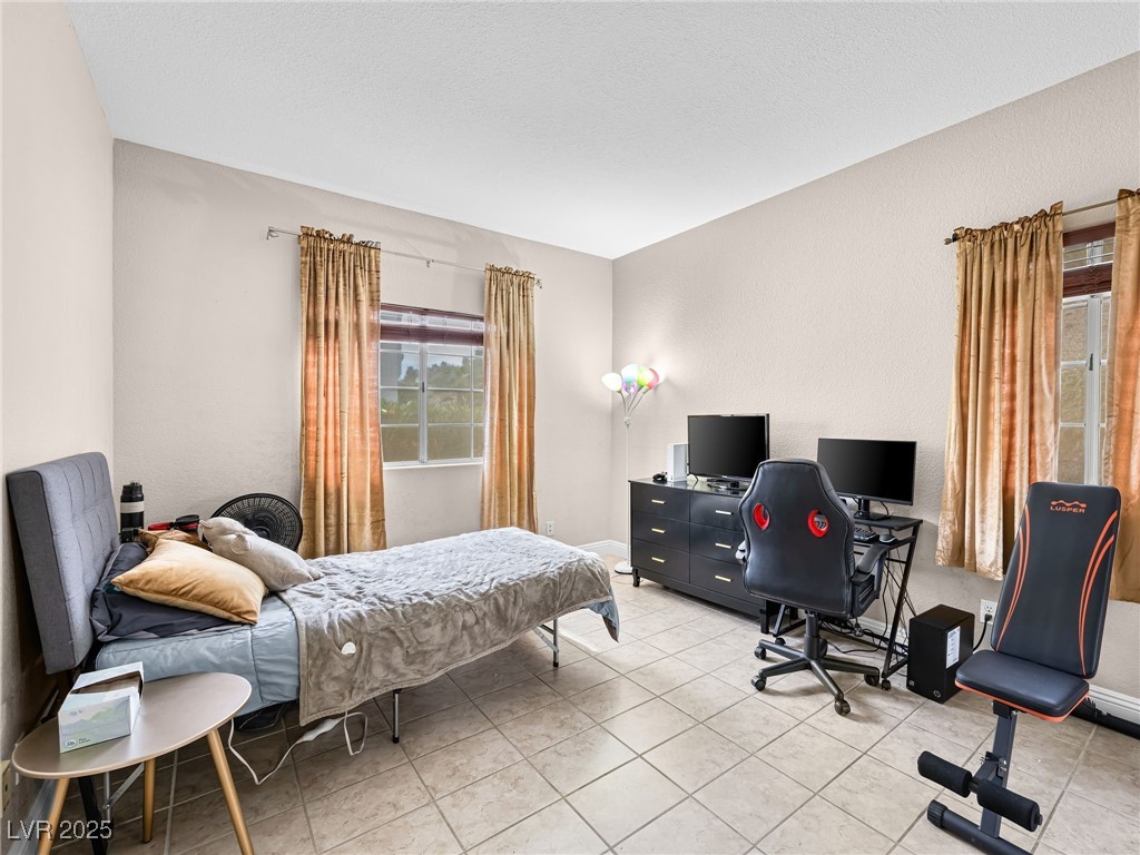 353 Seine Way, Unit N Henderson, NV 89014 - Photo 15 of 36 Bedroom with light tile patterned floors.