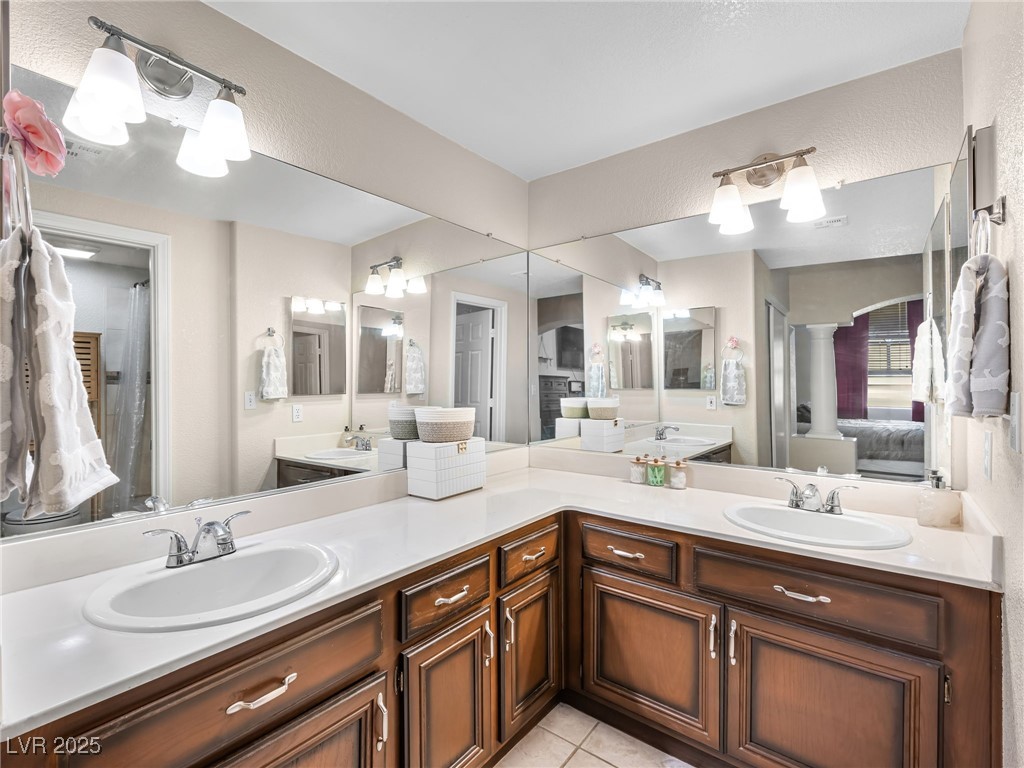 353 Seine Way, Unit N Henderson, NV 89014 - Photo 26 of 36 Full bath featuring tile patterned floors, double vanity, ensuite bath, and a sink
