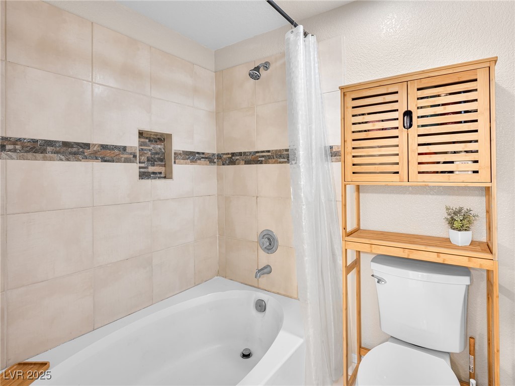 353 Seine Way, Unit N Henderson, NV 89014 - Photo 27 of 36 Full bath with toilet and shower / bathtub combination with curtain.