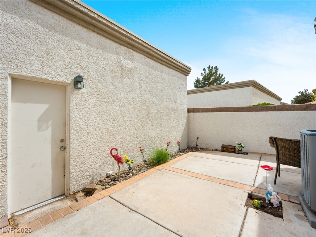353 Seine Way, Unit N Henderson, NV 89014 - Photo 28 of 36 View of patio with central AC unit and fence.