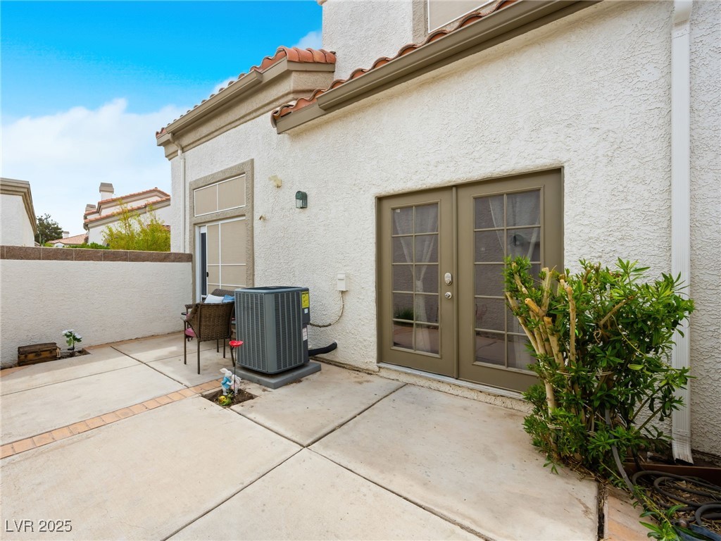 353 Seine Way, Unit N Henderson, NV 89014 - Photo 30 of 36 View of patio / terrace featuring central AC unit and french doors.
