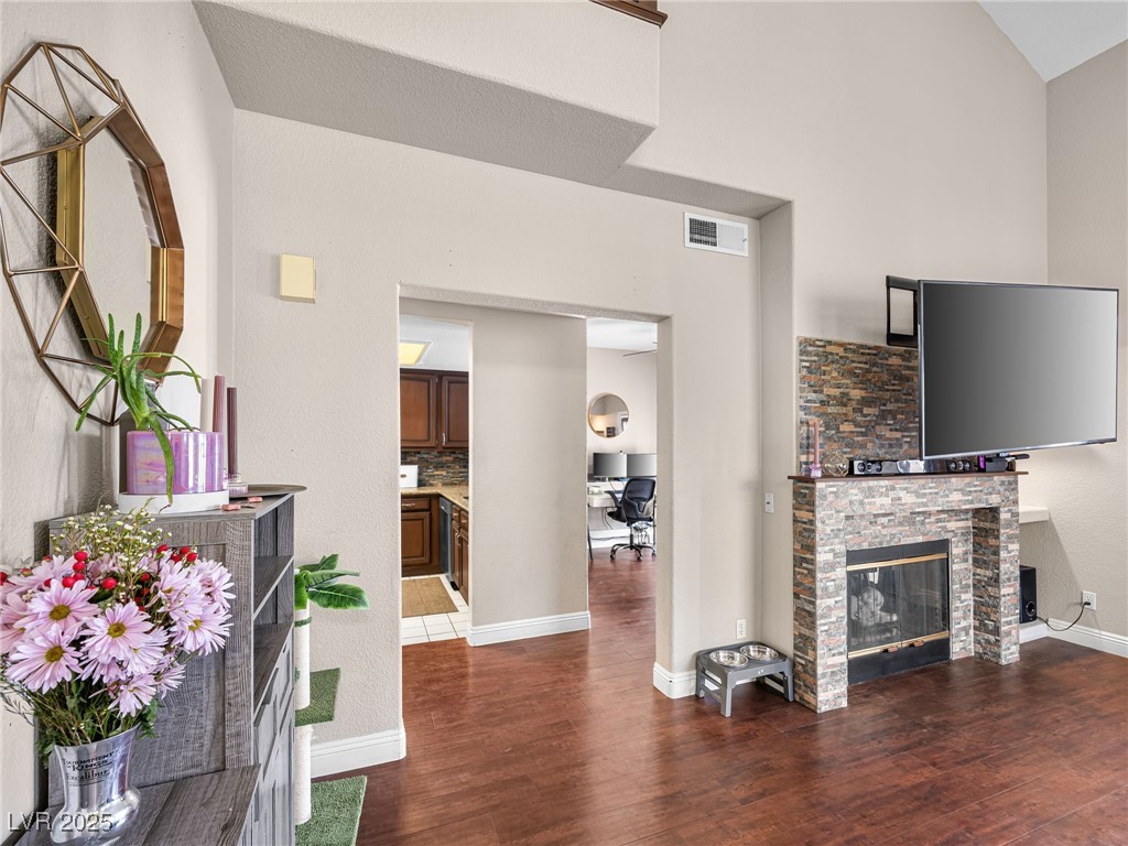 353 Seine Way, Unit N Henderson, NV 89014 - Photo 6 of 36 Living area with a stone fireplace, wood finished floors.
