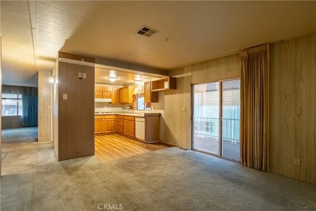 a view of a kitchen with refrigerator and a sink