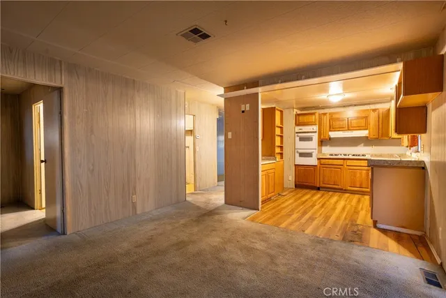 a view of a kitchen with a sink and a refrigerator