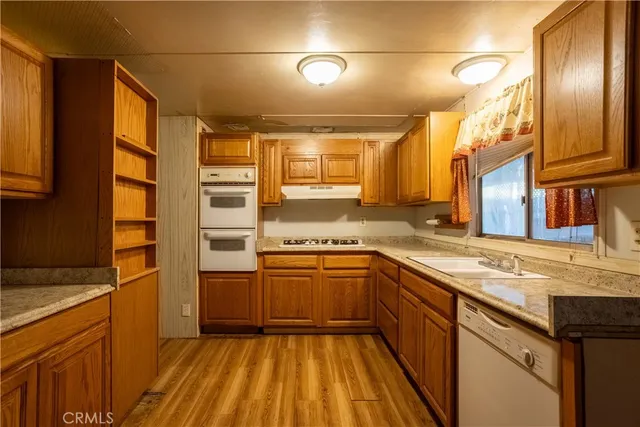 a kitchen with stainless steel appliances granite countertop a sink and cabinets