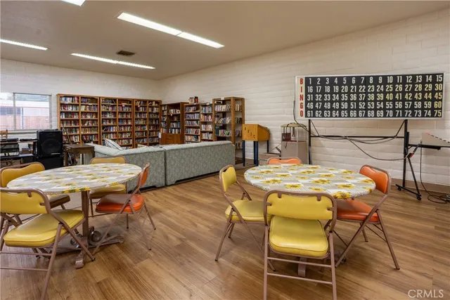 a living room with furniture and a book shelf