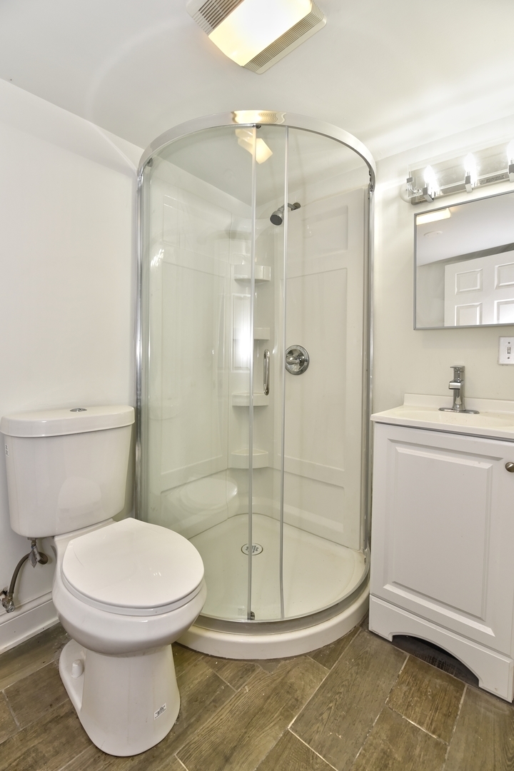 5605 Crestwood Road Matteson, IL 60443 - Photo 13 of 21 a bathroom with a toilet and a shower