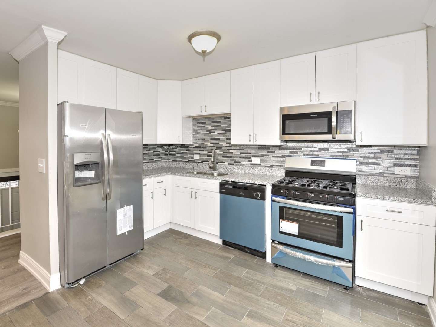 5605 Crestwood Road Matteson, IL 60443 - Photo 6 of 21 a kitchen with stainless steel appliances granite countertop a stove a refrigerator and a microwave