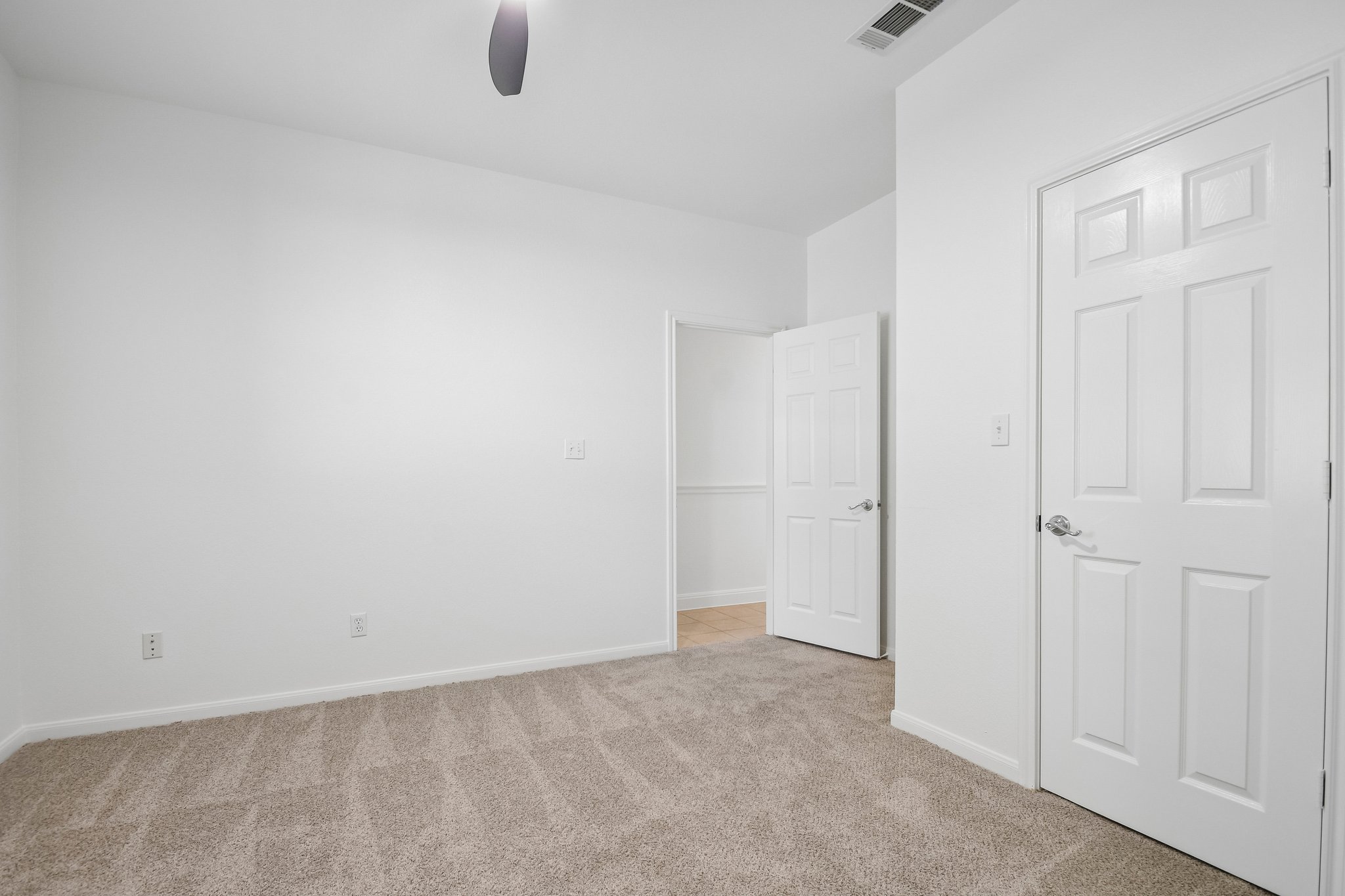 20609 Bridle Path Road Lago Vista, TX 78645 - Photo 15 of 30 A spacious, naturally illuminated room boasts soft carpeting and pristine white walls, ready for your personal touch.