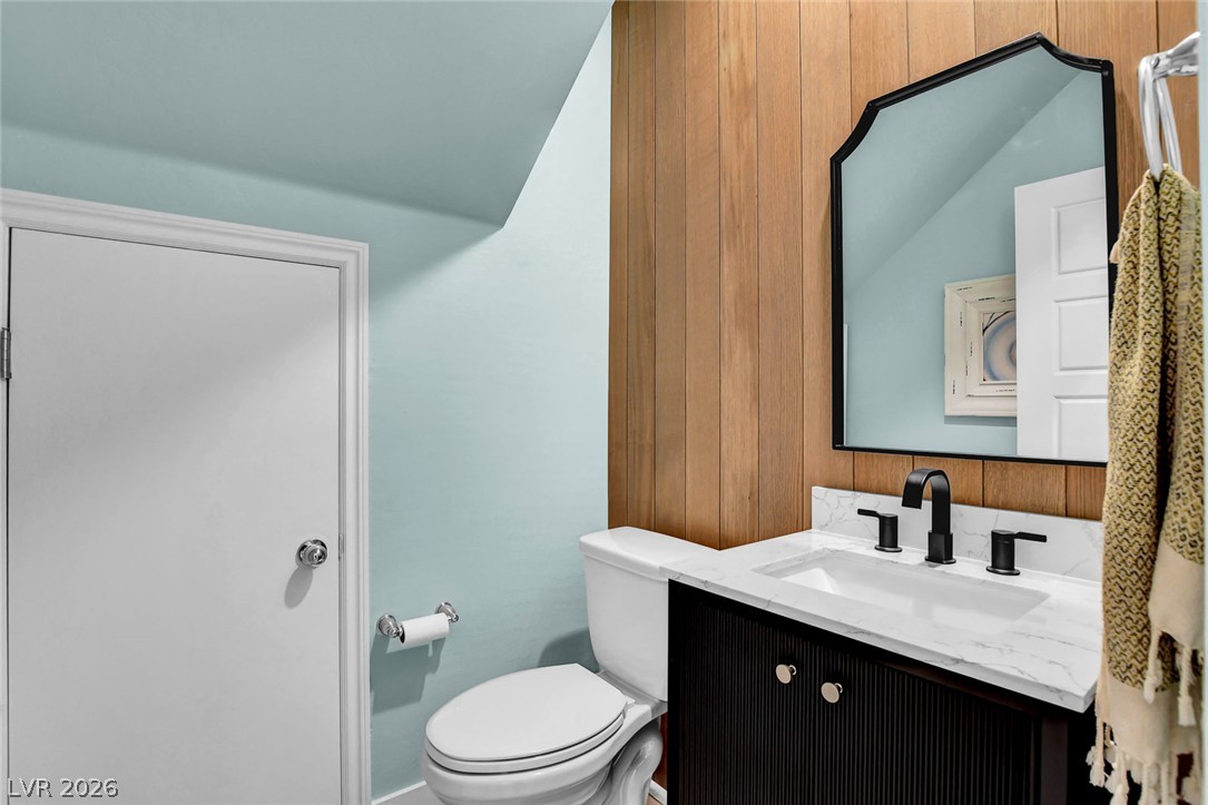 9688 Rankin Rdg Court Las Vegas, NV 89178 - Photo 18 of 53 A striking black vanity with a pristine white countertop, showcasing modern design in a compact space.
