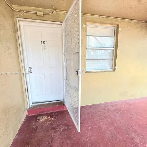 a kitchen with a white stove top oven and cabinets
