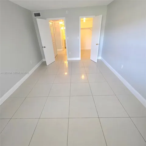 a view of hallway with a sink and a mirror