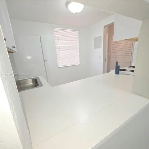 a kitchen with white cabinets