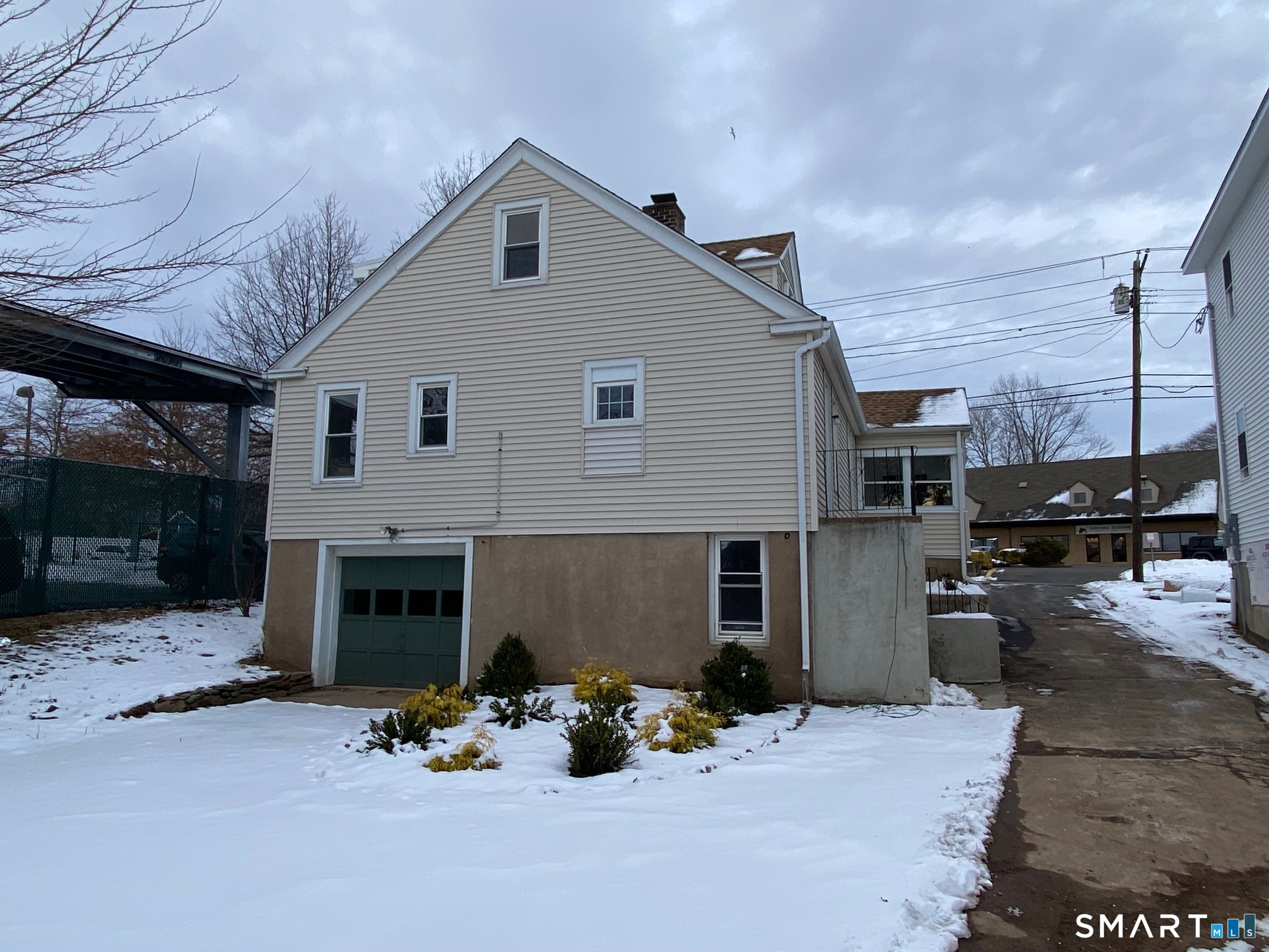 166 Saw Mill Road West Haven, CT 06516 - Photo 37 of 46 CUTE rear garden- under-house garage- the unplowed driveway curves around to the garage. There's a delicious Chinese Food Restaurant and Deli across the street!!