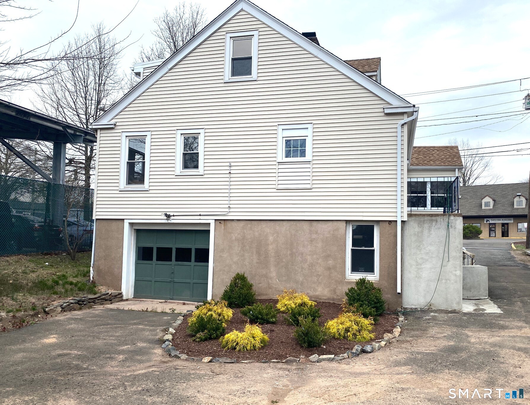 166 Saw Mill Road West Haven, CT 06516 - Photo 38 of 46 a front view of a house with a yard and a garage