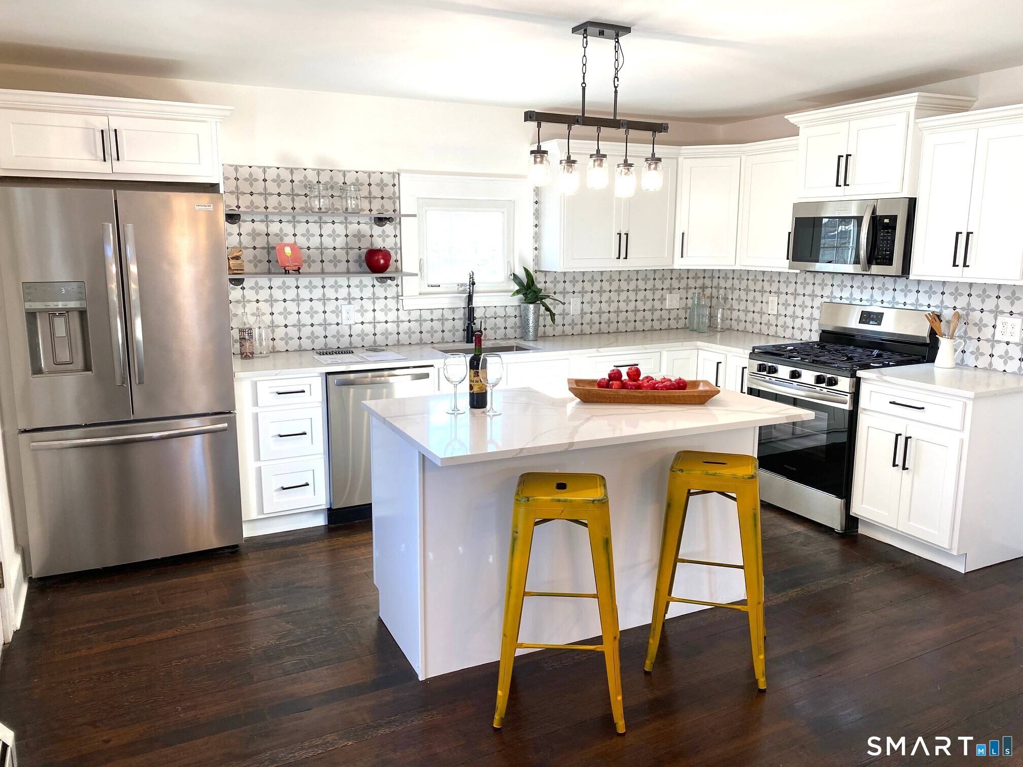 166 Saw Mill Road West Haven, CT 06516 - Photo 9 of 46 a kitchen with stainless steel appliances granite countertop a stove a refrigerator a sink dishwasher a dining table and chairs with wooden floor