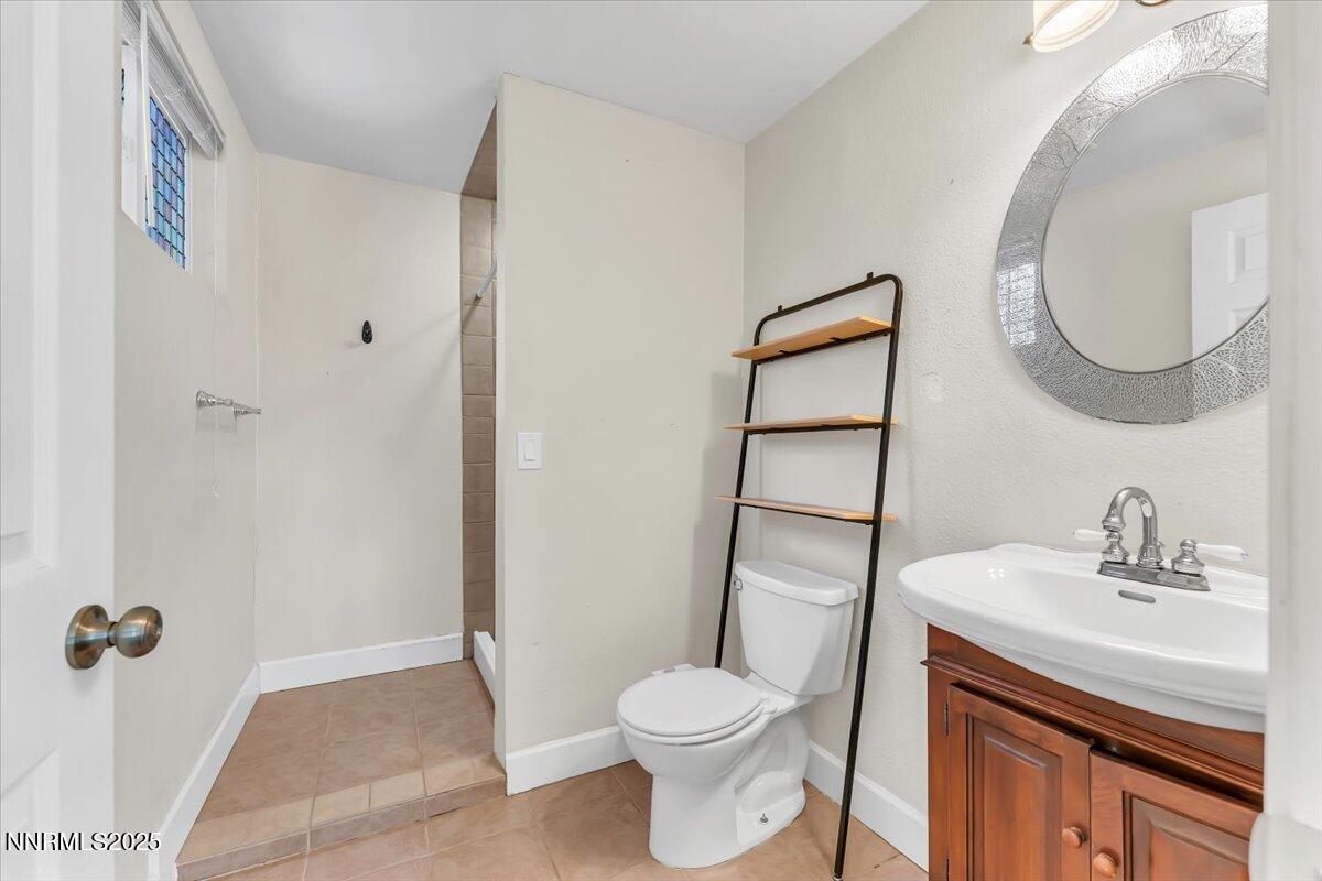 1375 Wesley Drive Reno, NV 89503 - Photo 17 of 35 a bathroom with a sink a toilet and a mirror