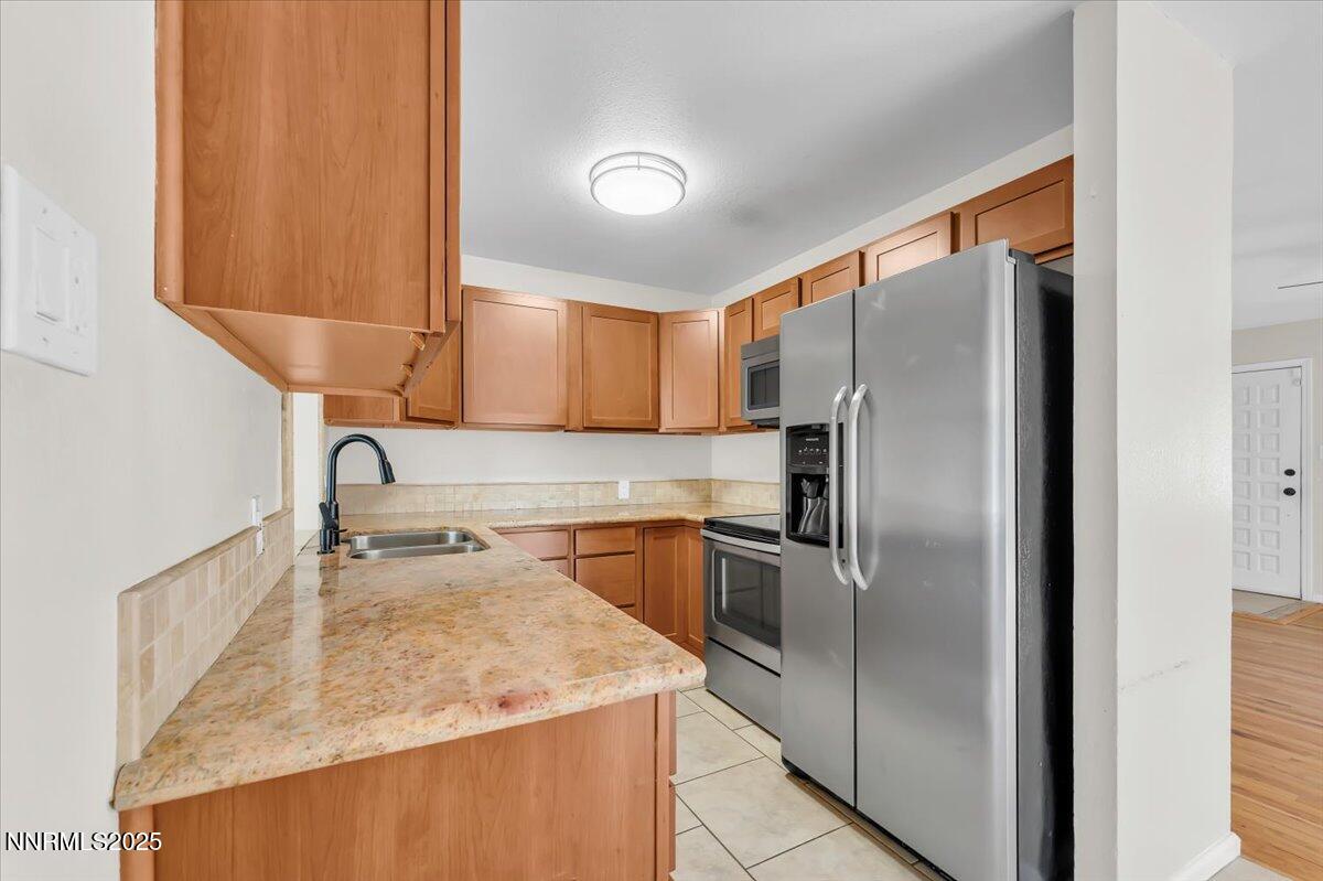 1375 Wesley Drive Reno, NV 89503 - Photo 6 of 35 a kitchen with stainless steel appliances granite countertop a refrigerator and a sink
