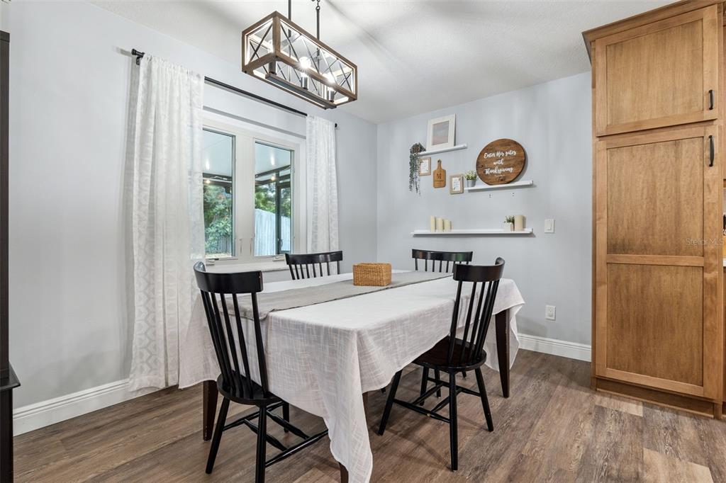 859 Benchwood Drive Winter Springs, FL 32708 - Photo 12 of 35 a view of a dining room with furniture wooden floor and a chandelier
