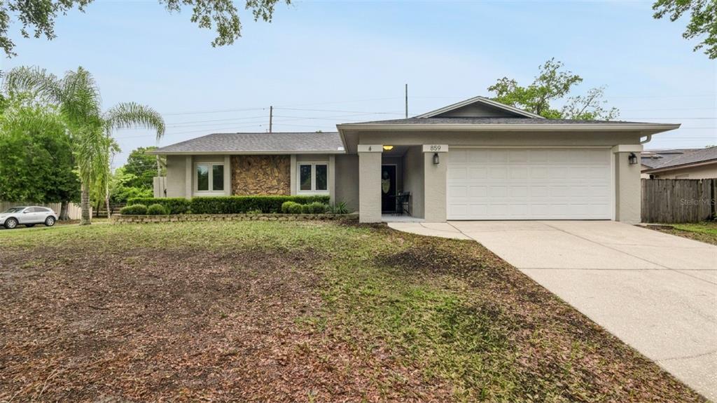 859 Benchwood Drive Winter Springs, FL 32708 - Photo 2 of 35 a front view of a house with a yard and garage