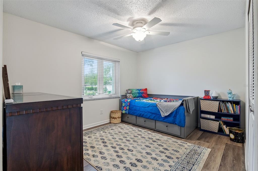 859 Benchwood Drive Winter Springs, FL 32708 - Photo 22 of 35 a bedroom with a bed and a chandelier