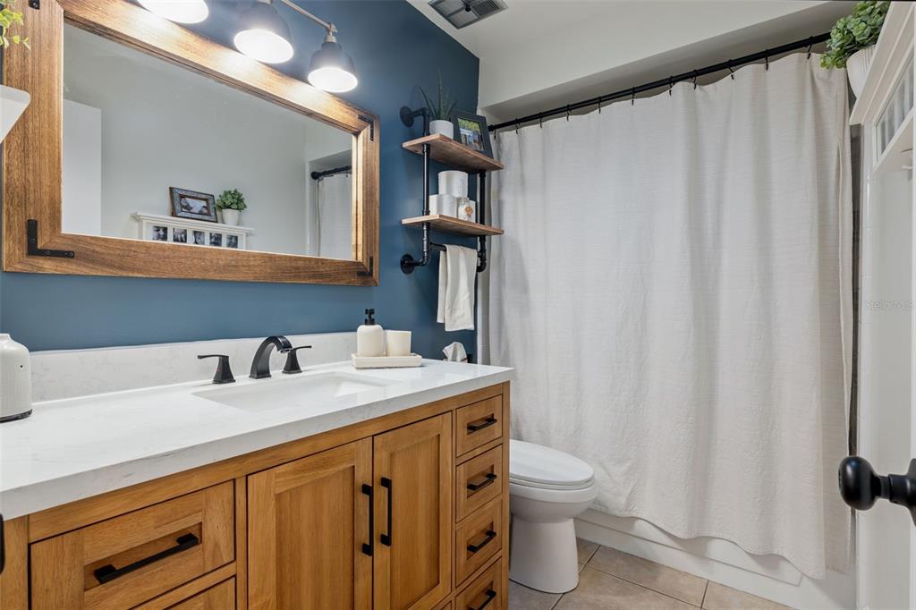 859 Benchwood Drive Winter Springs, FL 32708 - Photo 25 of 35 a bathroom with a granite countertop sink toilet and mirror
