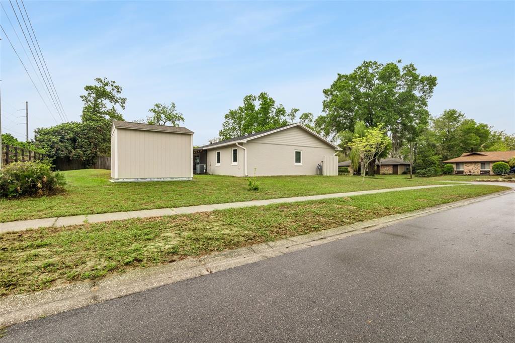 859 Benchwood Drive Winter Springs, FL 32708 - Photo 34 of 35 a view of a house with a yard and garage