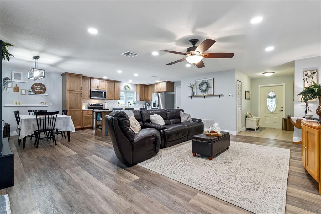859 Benchwood Drive Winter Springs, FL 32708 - Photo 8 of 35 a living room with furniture kitchen view and a chandelier