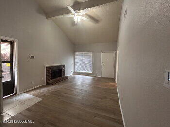 3421 Hyden Avenue Lubbock, TX 79407 - Photo 3 of 16 an empty room with windows and fireplace