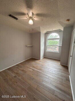 3421 Hyden Avenue Lubbock, TX 79407 - Photo 6 of 16 an empty room with wooden floor and windows