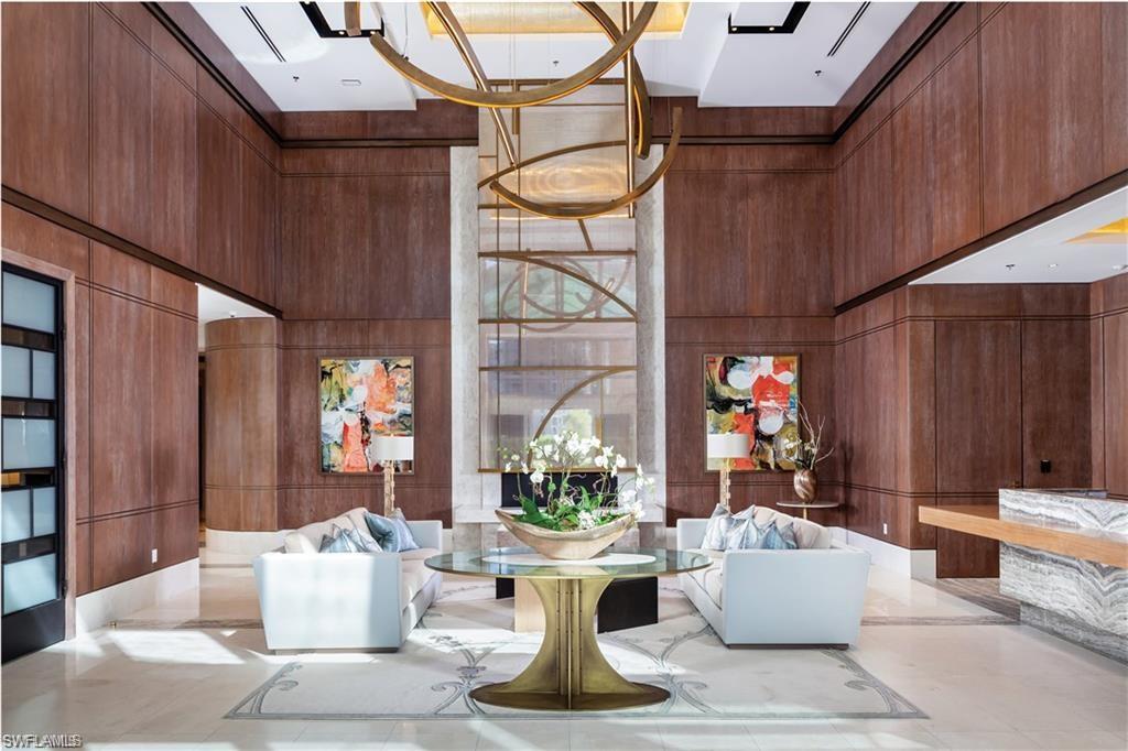 6897 Grenadier Boulevard, Unit 1101 Naples, FL 34108 - Photo 3 of 14 a living room with patio furniture and a potted plant