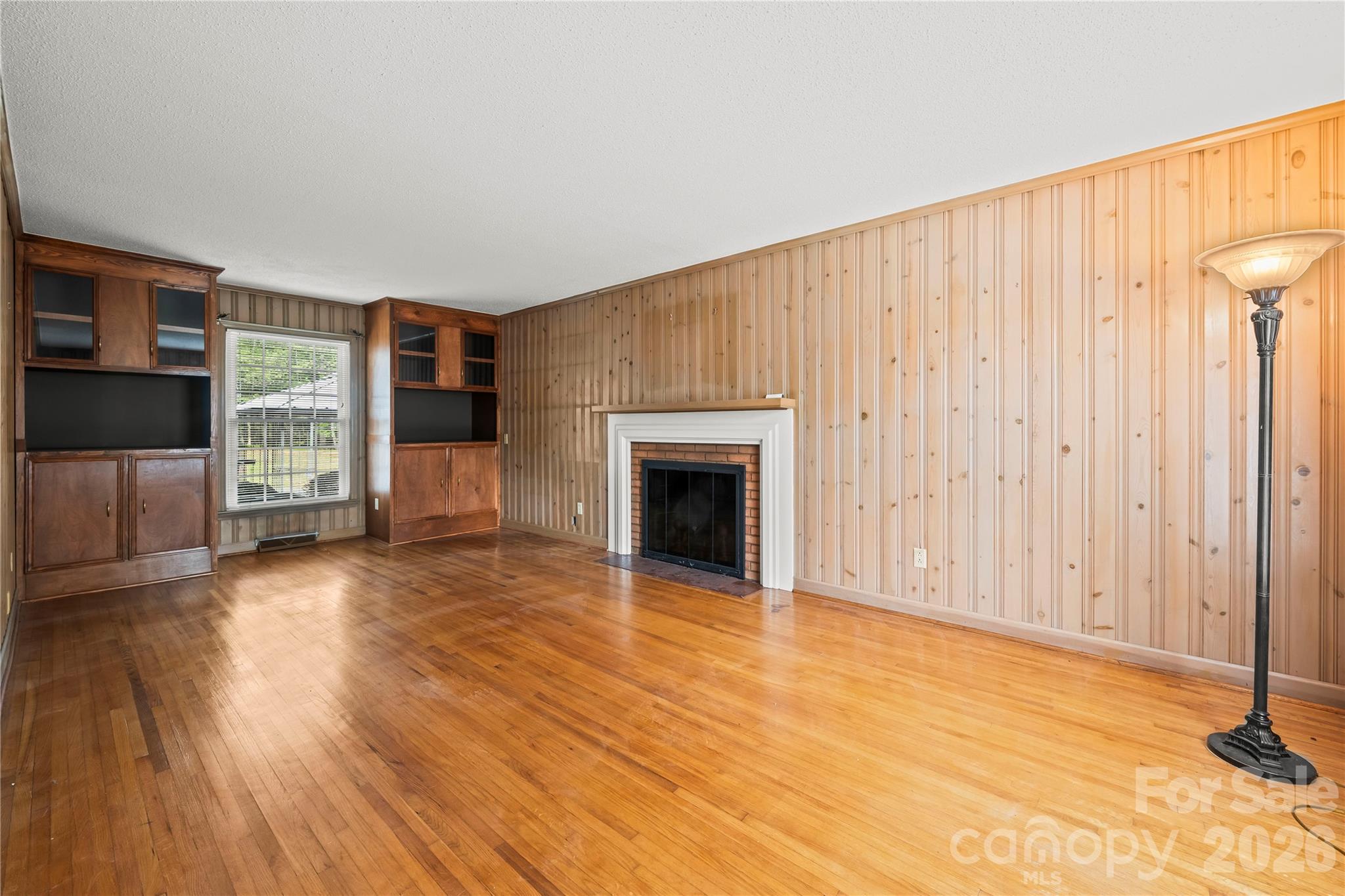 10670 Troutman Road Midland, NC 28107 - Photo 12 of 37 a view of a livingroom with wooden floor and a fireplace