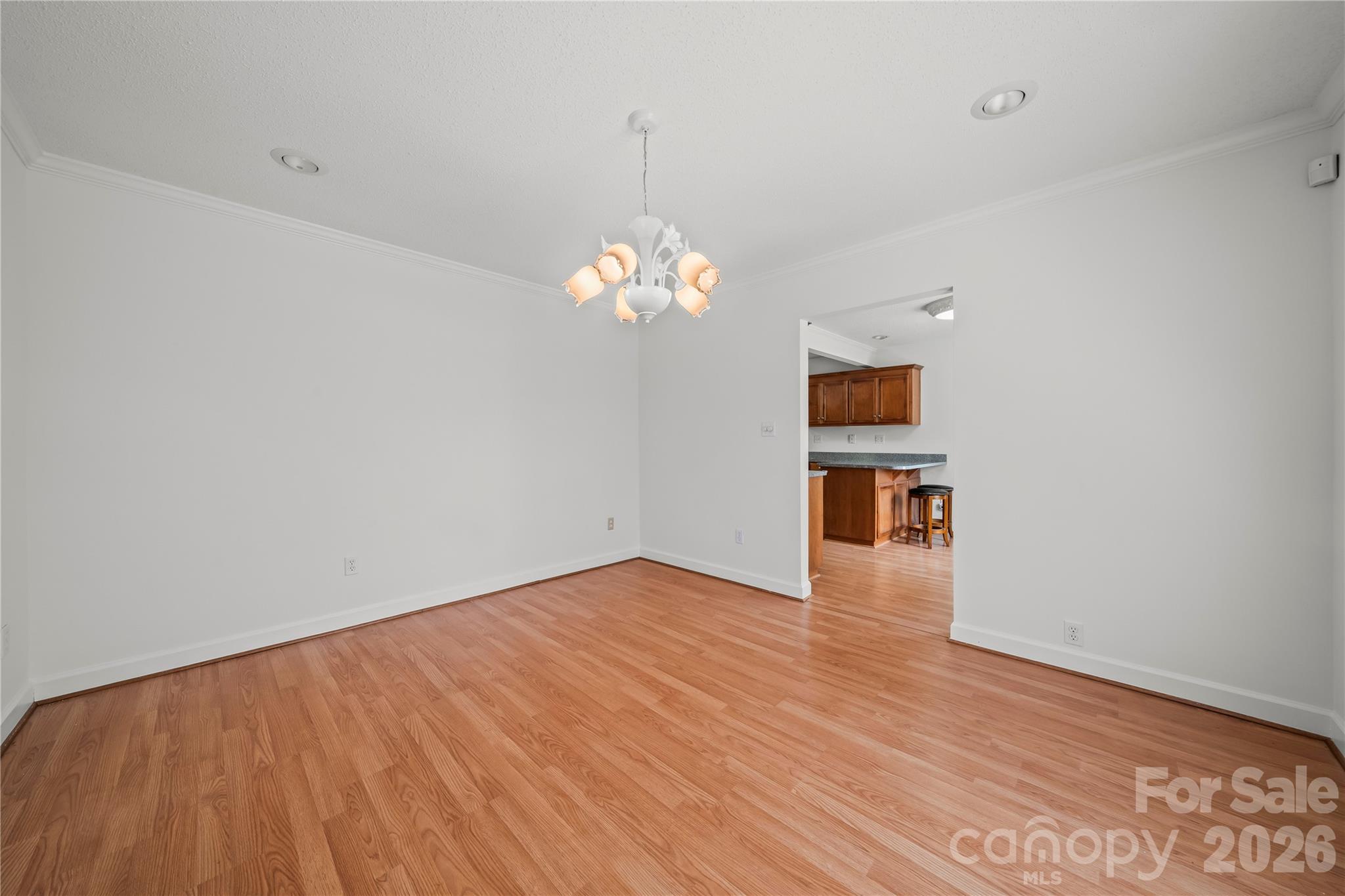 10670 Troutman Road Midland, NC 28107 - Photo 17 of 37 a view of a kitchen with wooden floor and a chandelier