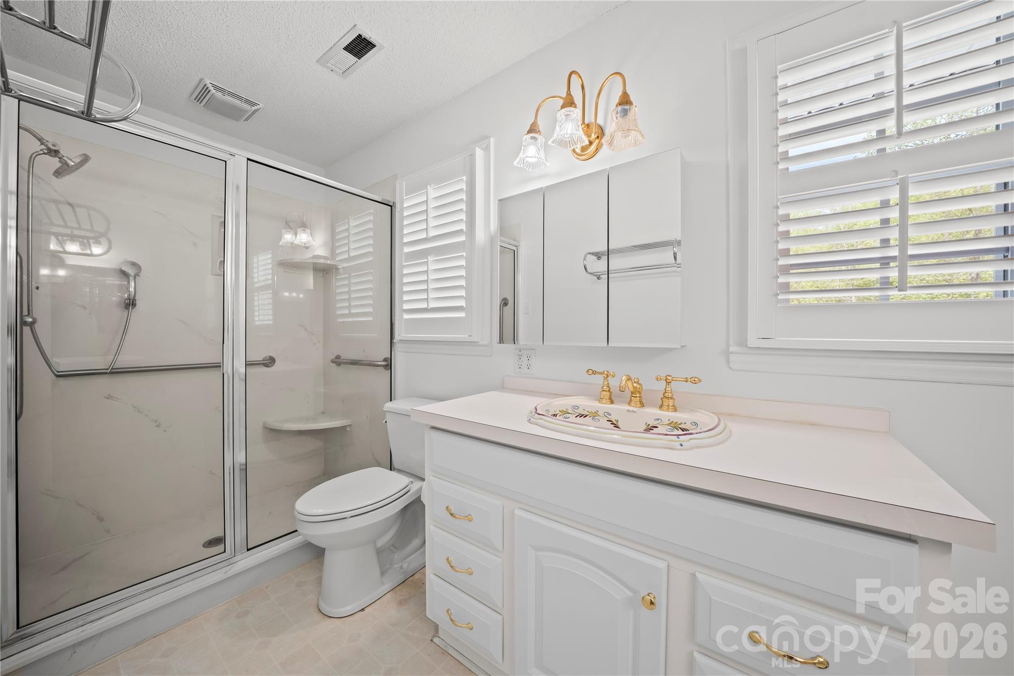 10670 Troutman Road Midland, NC 28107 - Photo 25 of 37 a bathroom with a sink toilet and shower