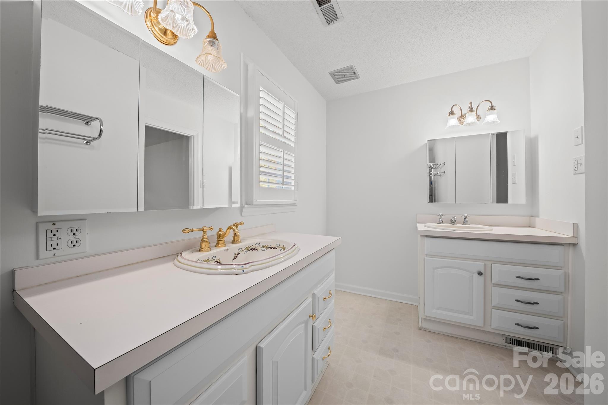 10670 Troutman Road Midland, NC 28107 - Photo 27 of 37 a bathroom with a sink vanity and a mirror